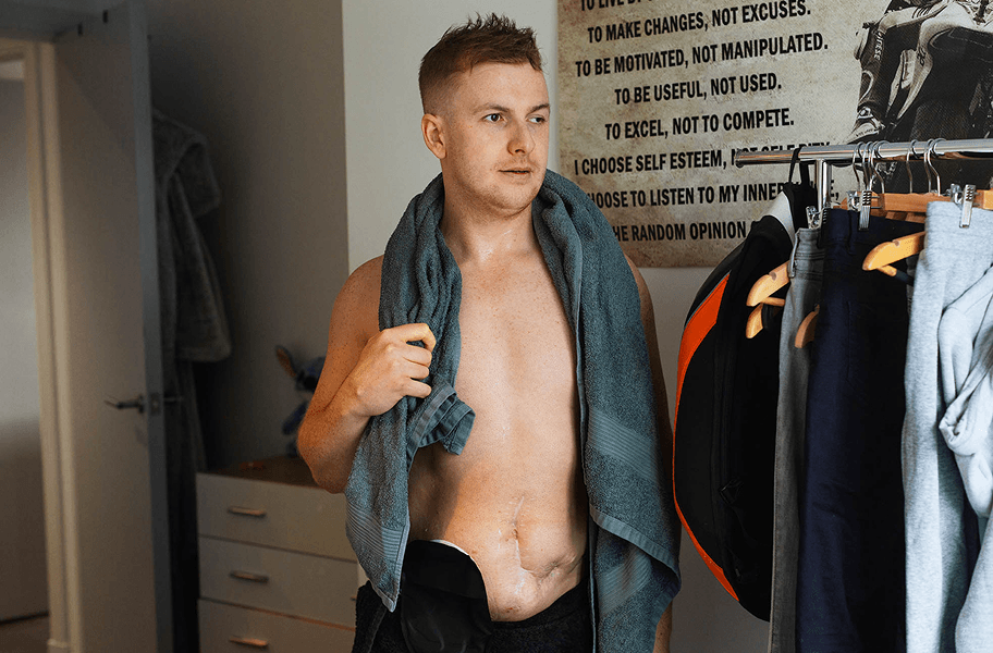 man with stoma choosing clothes at home